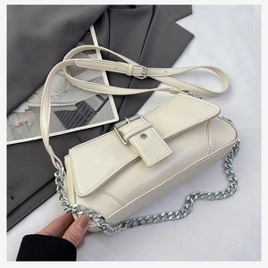 Detail of cream PU leather shoulder bag with vintage crackle texture and silver chain strap