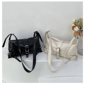 Minimalist leather shoulder bags in black and white with silver metal buckles