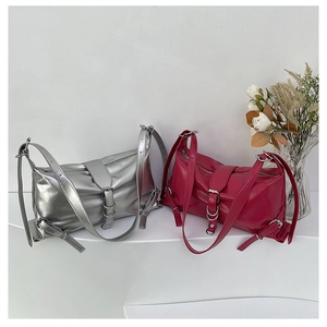 Detail of trendy metallic silver and magenta textured faux leather shoulder bags