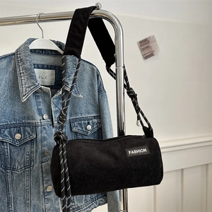 Black corduroy cylinder crossbody bag with fashion patch and woven rope strap