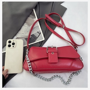 Red retro leather crossbody bag with silver chain strap shown next to a smartphone