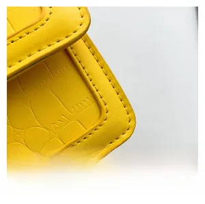 Detail of yellow crocodile pattern leather bag with high-quality stitching craftsmanship