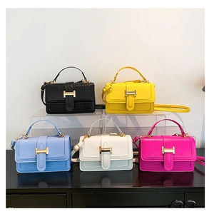 Five crocodile pattern square bags in various colors featuring gold metallic buckles