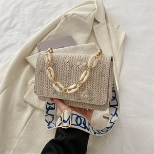 Straw shoulder bag with floral embroidery, chain detail and patterned wide strap