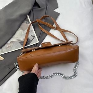 Retro dark brown oily leather shoulder bag with silver chain strap on white background