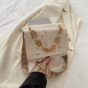 Straw weave shoulder bag with floral embroidery and elegant gold metal chain strap