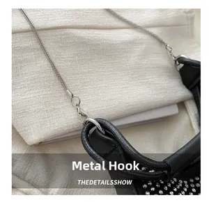 Detail shot of the silver metal hardware hook and chain on the rhinestone evening bag