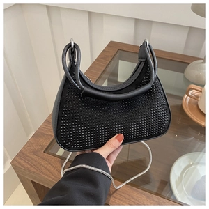 Détail du sac croissant à perles noires avec texture daim et fine bandoulière argentée
