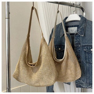 Close-up of woven mesh straw tote bags in beige and khaki with leather-feel shoulder straps