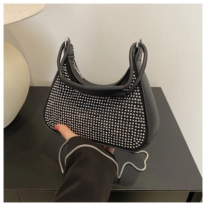 Détail du sac demi-lune noir avec clous argentés et bandoulière en chaîne métal