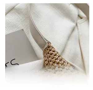 Macro detail of hand-woven straw tote bag with premium leather straps and fine stitching