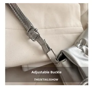 Close-up of adjustable silver metal buckle and soft leather strap on tote bag