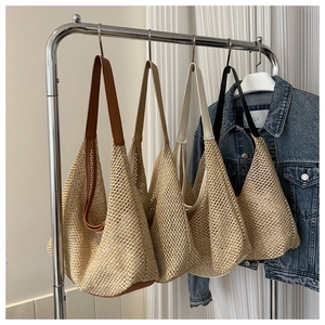 Detail of woven mesh shoulder bag with contrasting leather straps in multiple colors