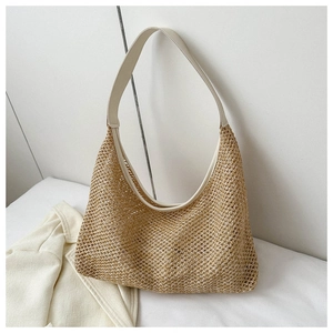 Close-up of beige woven straw tote bag featuring intricate mesh pattern and leather strap