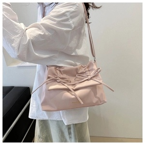 Chic pink shoulder bag with elegant ruffles and bow details in soft high-quality PU leather