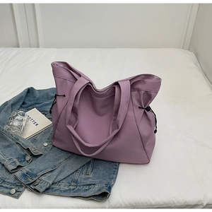 Detailed view of light purple waterproof nylon tote bag with side drawstring adjustments