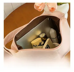 Spacious interior of pink tote bag showing tablet, umbrella, and phone storage