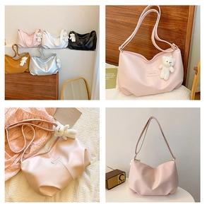Close-up of minimalist half-moon tote bags with cute bear pendants in five soft colors