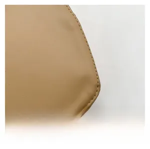 Close-up of the smooth camel leather texture and precise stitching on the heart handbag