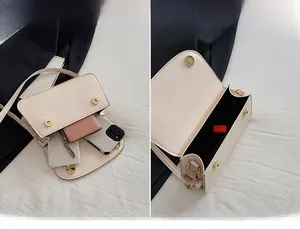 Internal view of the cream square crossbody bag showing large storage capacity