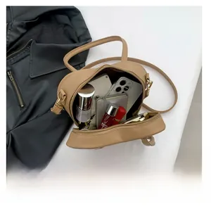 Top view showing spacious interior of the camel PU leather bag with daily essentials