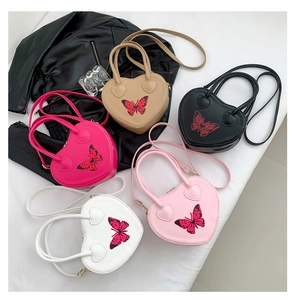 Detailed top view of five colorful heart-shaped bags with butterfly print and PU texture