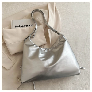 Close-up of metallic silver hobo bag with pleated texture and adjustable strap