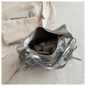 Spacious interior of silver bow tote bag showing organized wallet and accessories
