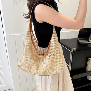 Large beige woven straw hobo bag with brown leather trim for summer beach and daily use