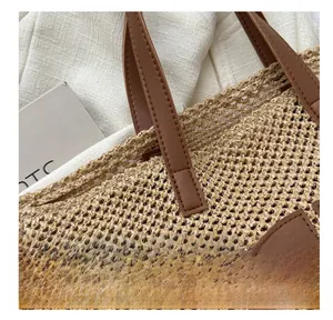 Detailed close-up of the woven straw texture and premium leather stitching on the tote bag