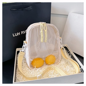 Detail of beige canvas bag featuring a transparent PVC window and yellow straps