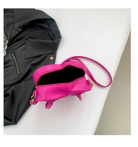 Top view of open heart-shaped crossbody bag in hot pink leather with golden zipper