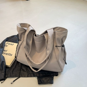 Minimalist light grey tote bag with functional drawstring details for modern urban commuting