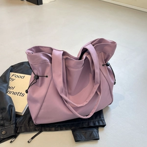 Purple drawstring tote bag for women featuring a spacious interior and versatile shoulder straps
