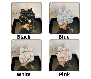 Detail view of mini tweed chain bags with bows in black, blue, white, and pink options