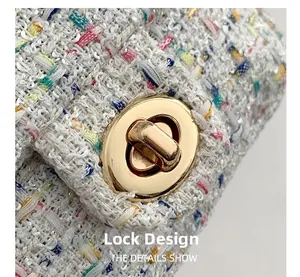 Macro detail of golden oval turn-lock clasp on multi-colored tweed crossbody bag