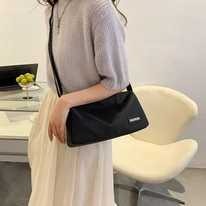 Lightweight black oxford fabric crossbody bag with adjustable strap and fashion label