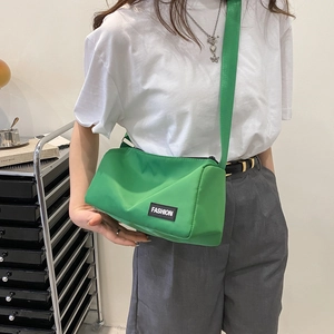 Bright green lightweight nylon crossbody bag for women with wide shoulder strap