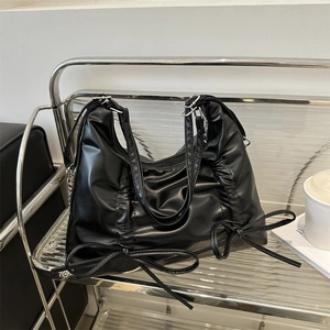 Fashionable black ruched tote bag with twin bow details and versatile shoulder strap