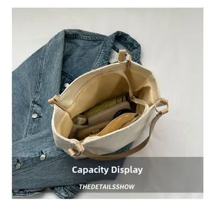 Spacious interior of beige canvas tote bag with compartments for daily essentials