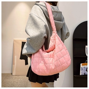 Detailed back view of pink quilted hobo bag with a plush padded shoulder strap