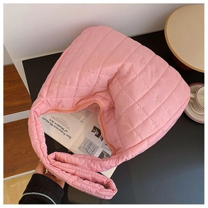 Top view of pink quilted hobo bag with square stitching on a lifestyle background