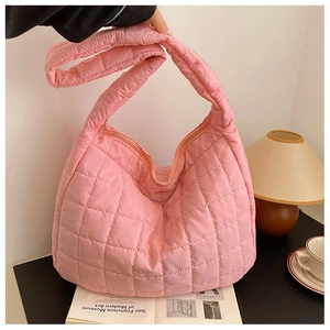 Detailed view of pink quilted puffer tote bag with glossy nylon finish and sturdy zipper