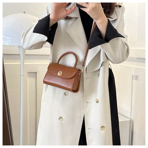 Brown vintage mini crossbody bag styled with a beige trench coat for a trendy look