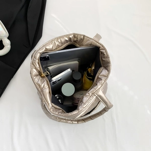 Champagne gold quilted tote bag with large capacity showing daily items like a tablet and phone