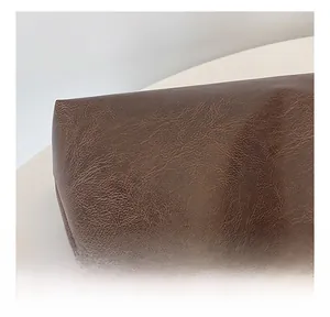 Close-up of deep brown pebbled faux leather material showing texture and quality