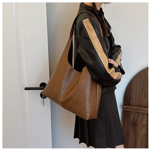 Brown vintage leather tote bag shown on shoulder for daily commute and casual style