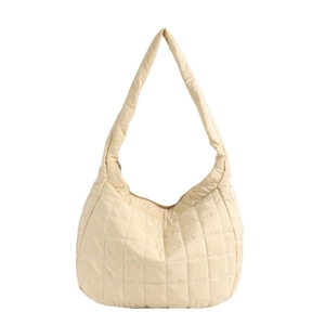 Quilted cream puffer shoulder bag with minimalist square stitching and wide strap