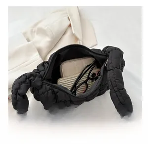 Interior view of black quilted shoulder bag showing large capacity for phone and wallet