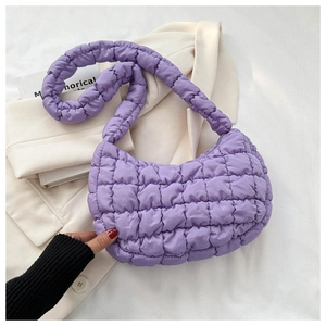 Detail shot of purple quilted puffy cloud bag with soft textured square stitching